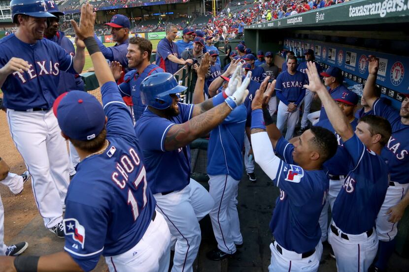 Texas Rangers first baseman Prince Fielder (84) is congratulated by teammates after his...