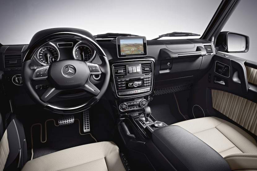 The hooded instrument panel on the 2013  G550 Mercedes-Benz houses black-faced gauges, and a...