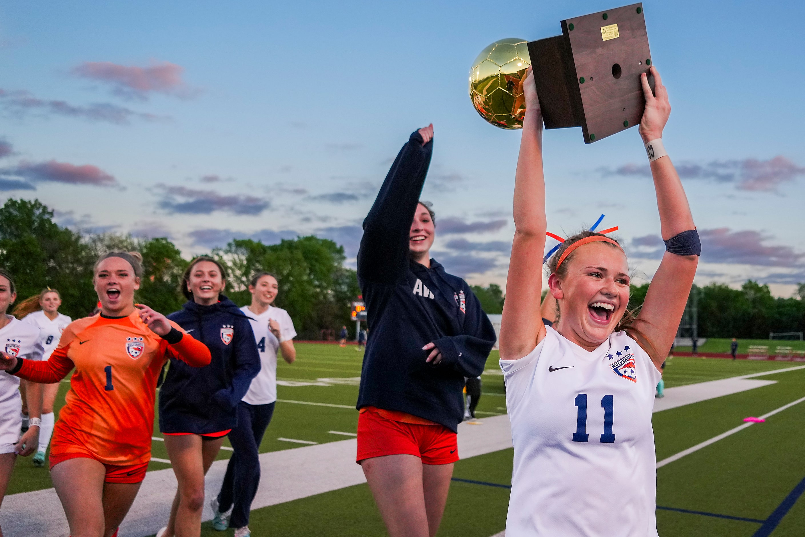 Frisco Wakeland defender LG Moncrief (11) lifts the game trophy with teammates after a...