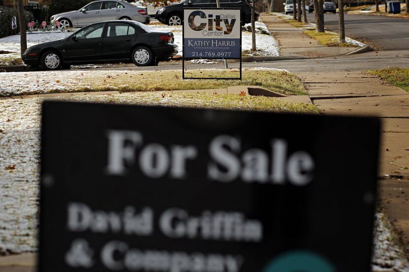 For sale signs line two houses in the M Streets neighborhood of Dallas. (G.J. McCarthy/The...