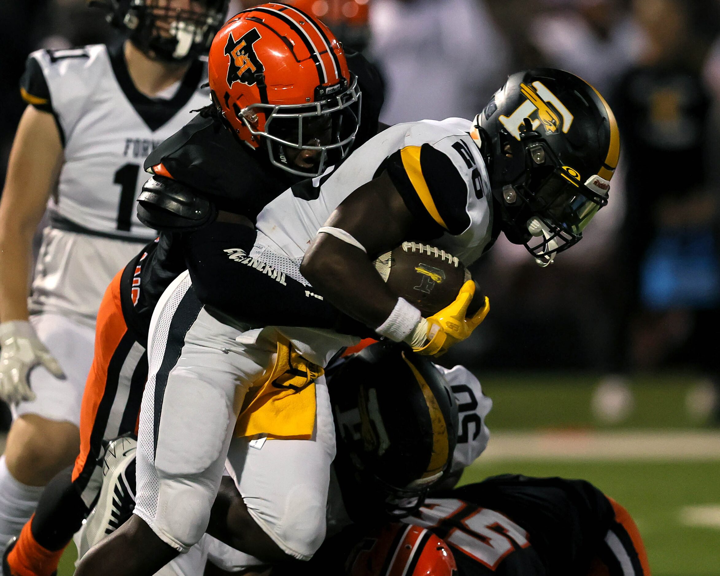 Forney running back Javian Osborne (26) gets stuffed on the run by Lancaster defensive end...