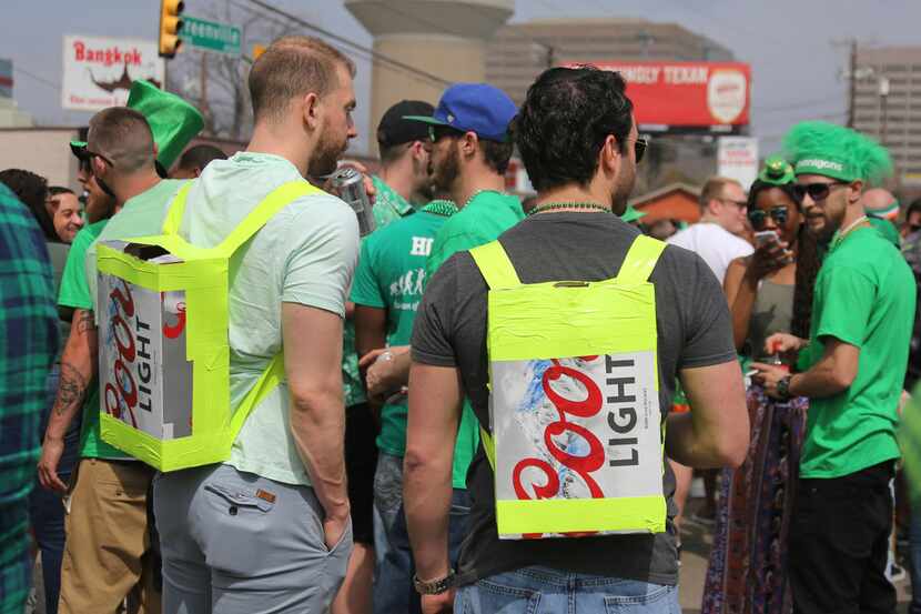 Two men come prepared with appropriate homemade "backpacks" during the Dallas St. Patrick's...