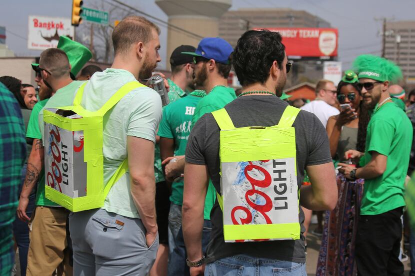 Two men come prepared with appropriate homemade "backpacks" during the Dallas St. Patrick's...