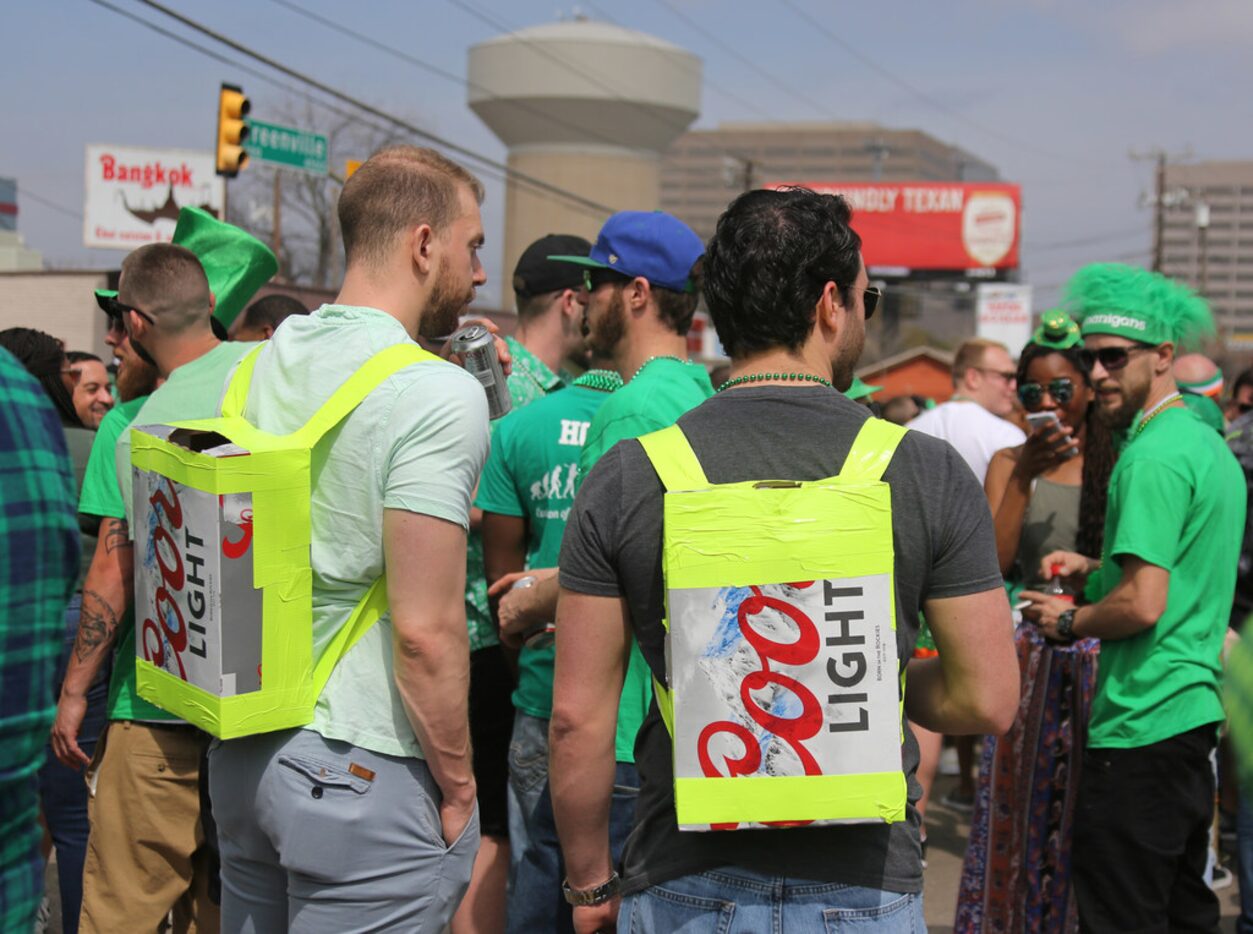 Two men come prepared with appropriate homemade "backpacks" during the Dallas St. Patrick's...