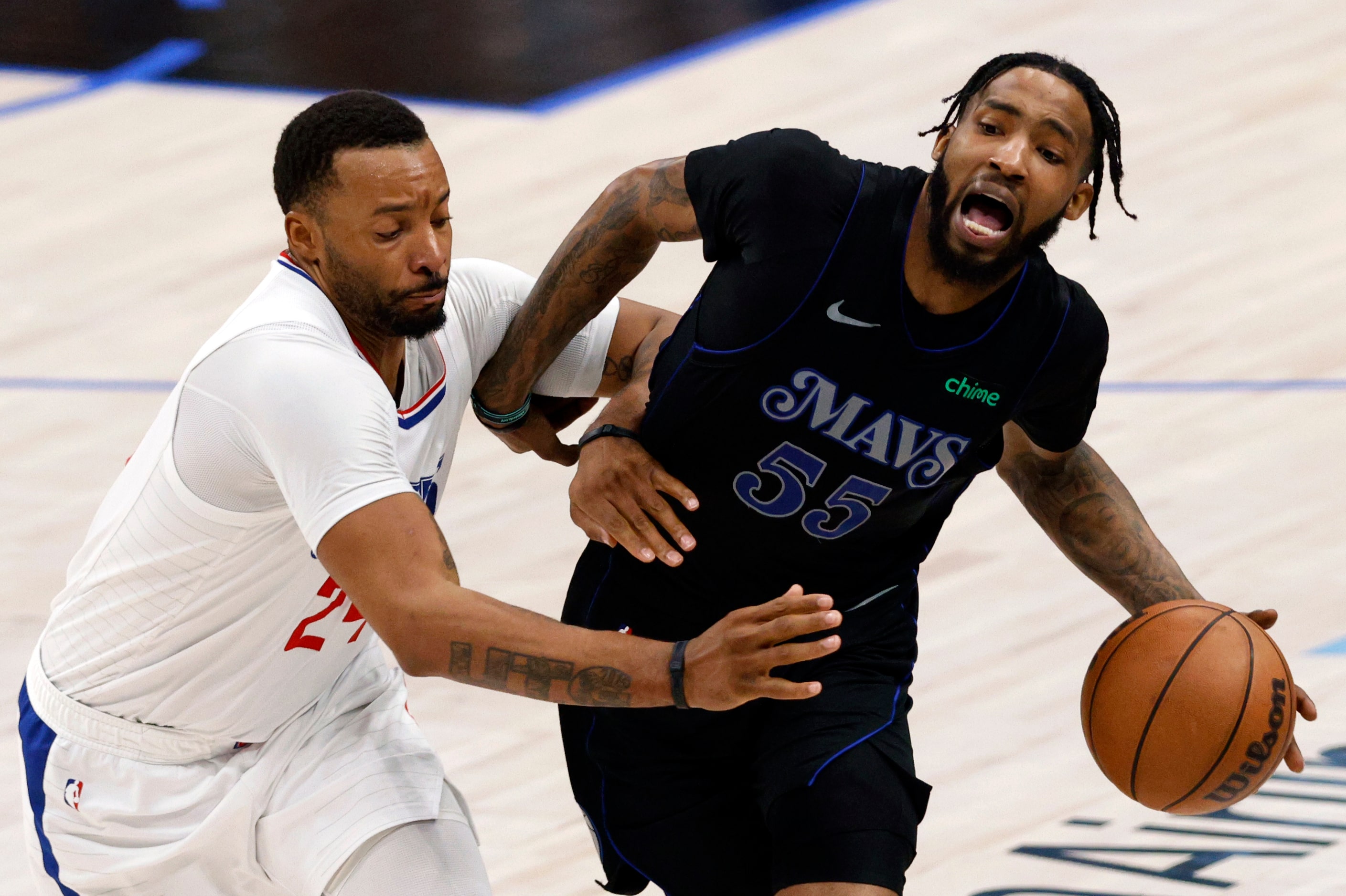 LA Clippers guard Norman Powell (24) fouls Dallas Mavericks forward Derrick Jones Jr. (55)...