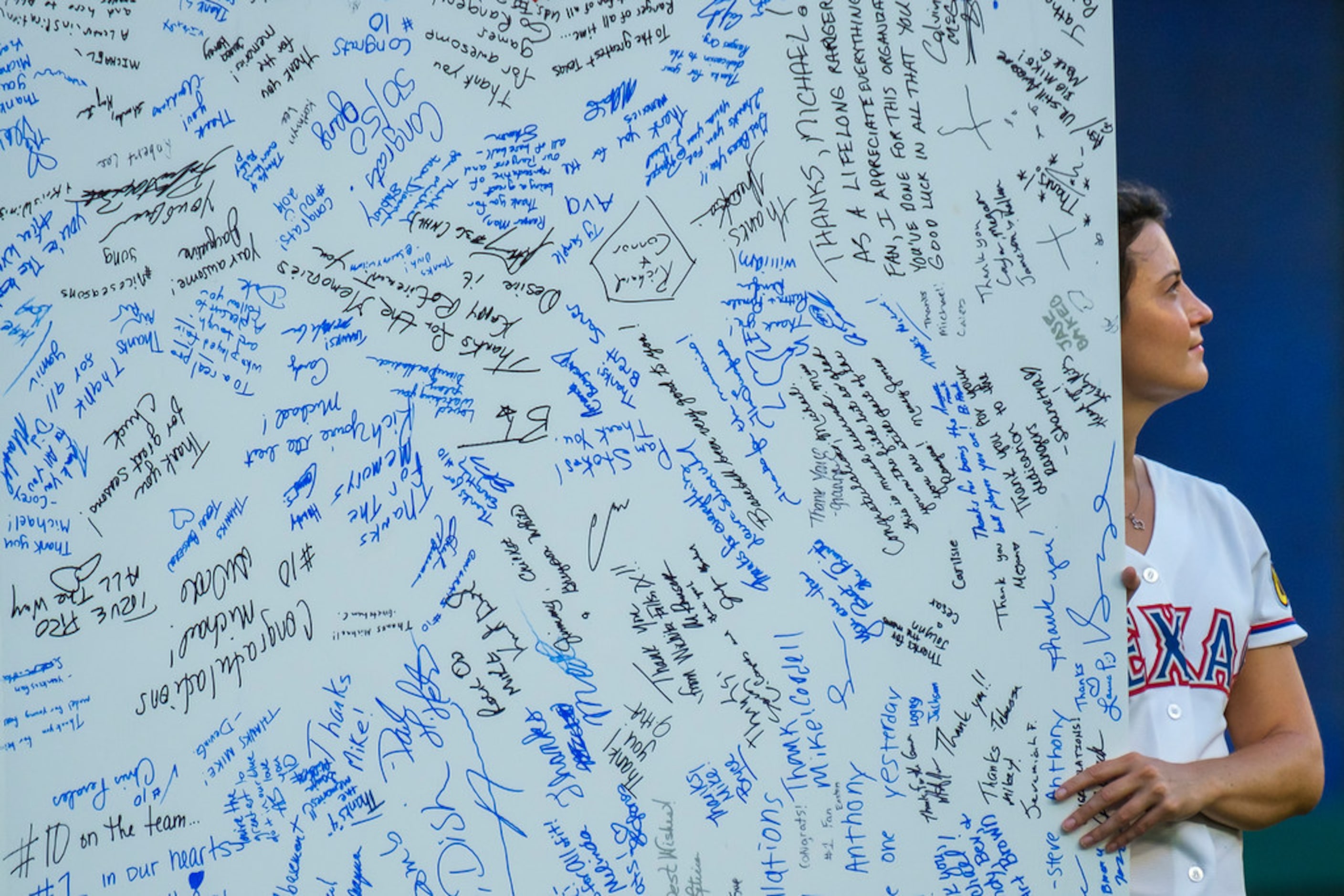 Giant card filled with good wishes is displayed during ceremonies to retire Michael Young's...