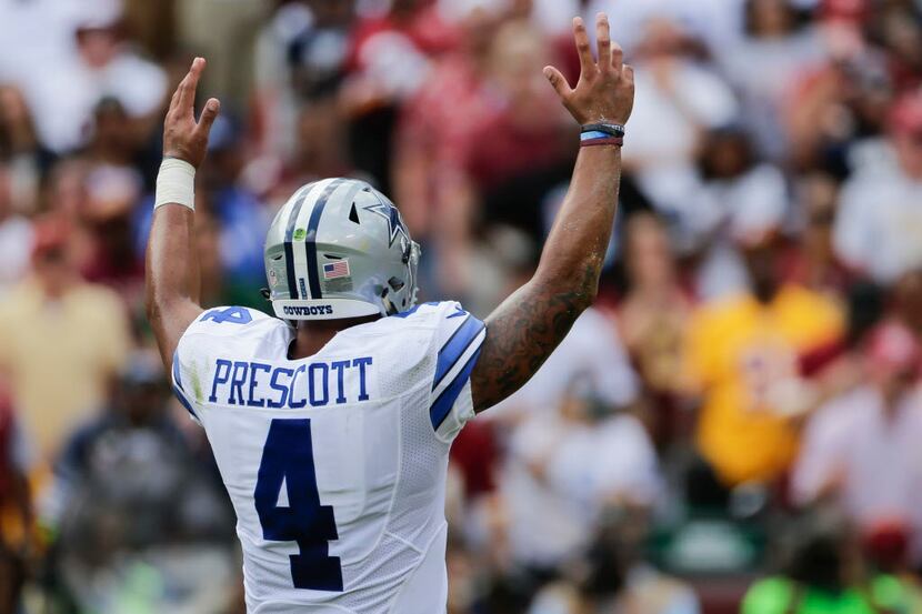 Dallas Cowboys quarterback Dak Prescott (4) celebrates running back Ezekiel Elliott's...