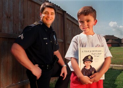 ORG XMIT: S11A47F11 Dallas police Senior Cpl. Ronald Pinkston with his son Trevor Pinkston,...