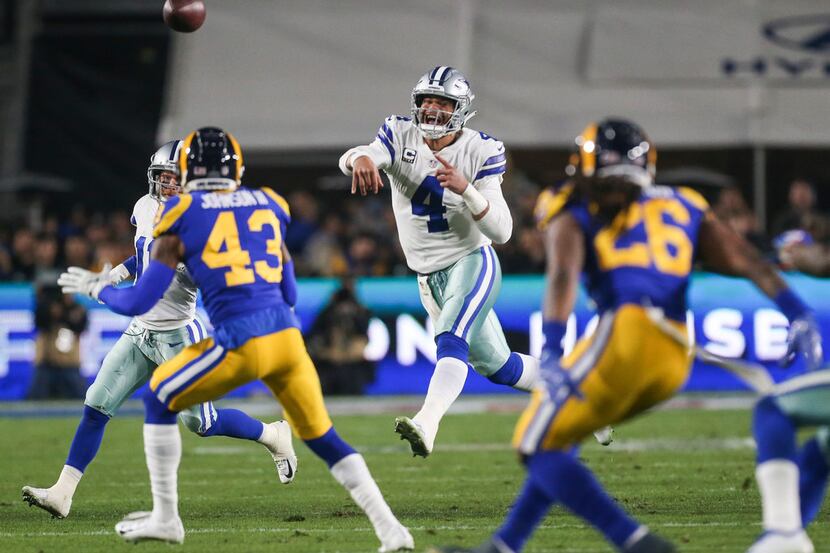 FILE - Cowboys quarterback Dak Prescott (4) fires off a pass during the first half of an NFC...