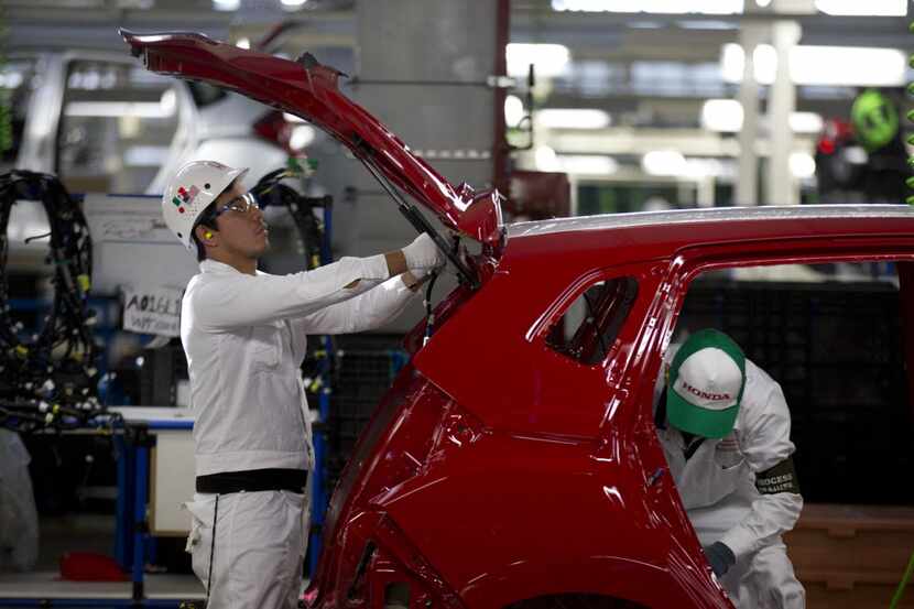 Employees at work in the new multibillion-dollar Honda car plant in Celaya, in the central...