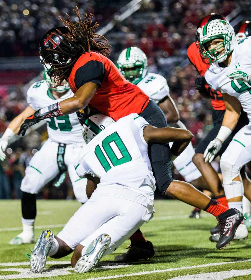 Euless Trinity defensive back Shamar Morton (8) is tackled by Southlake Carroll defensive...