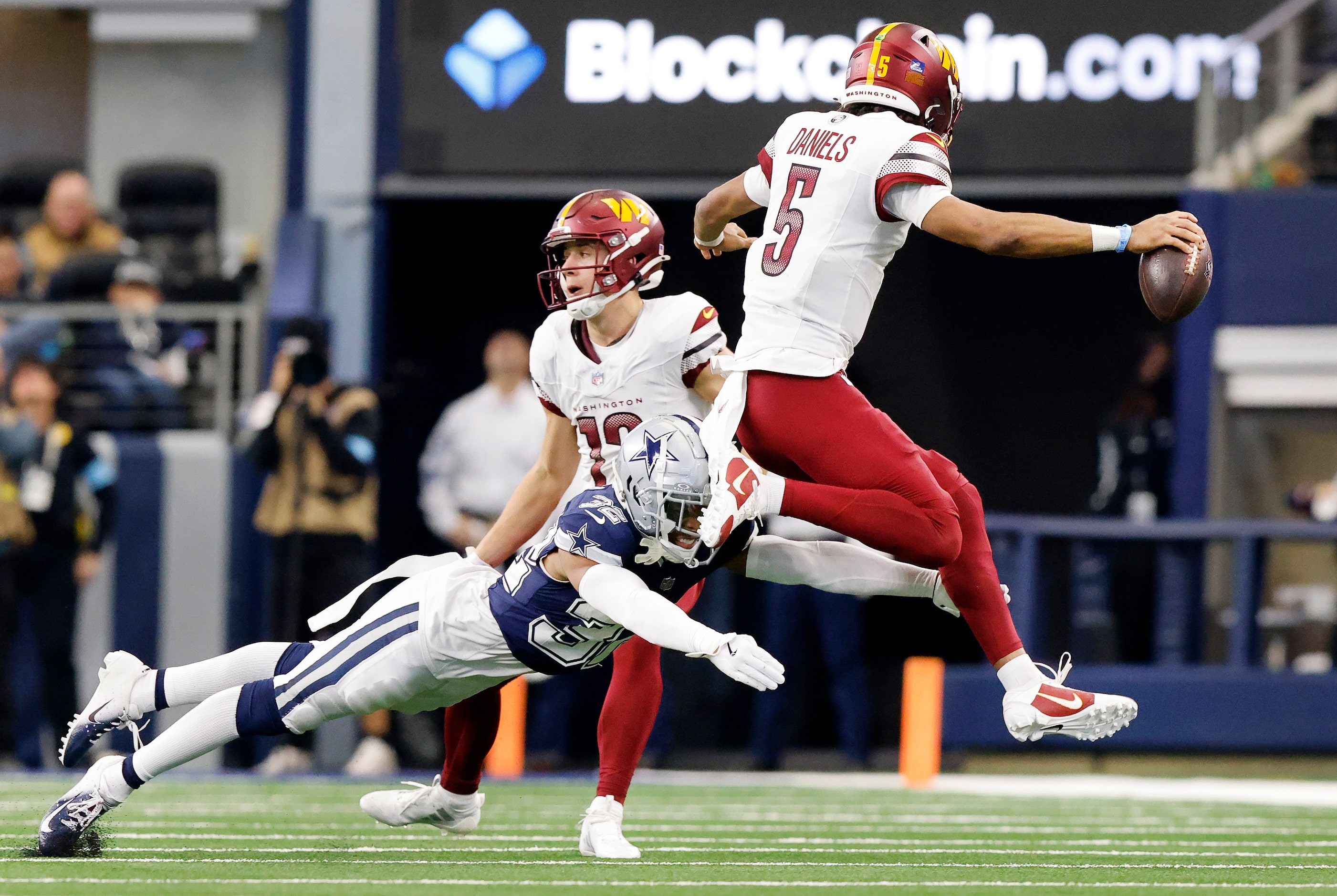 Dallas Cowboys cornerback Troy Pride Jr. (32) tries to tackle Washington Commanders...