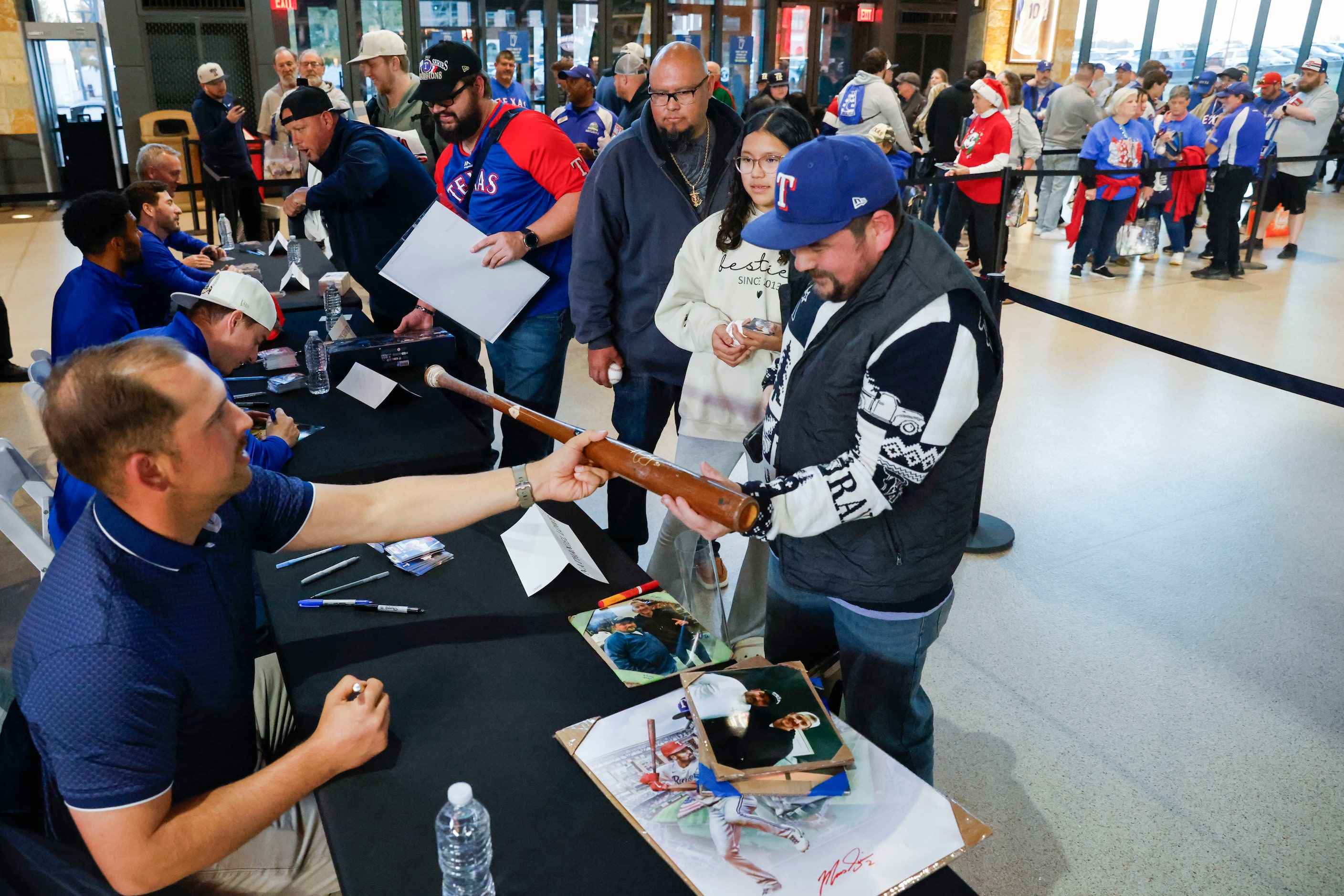 Texas Rangers second baseman Marcus Semien interacts with fans while signing autographs...