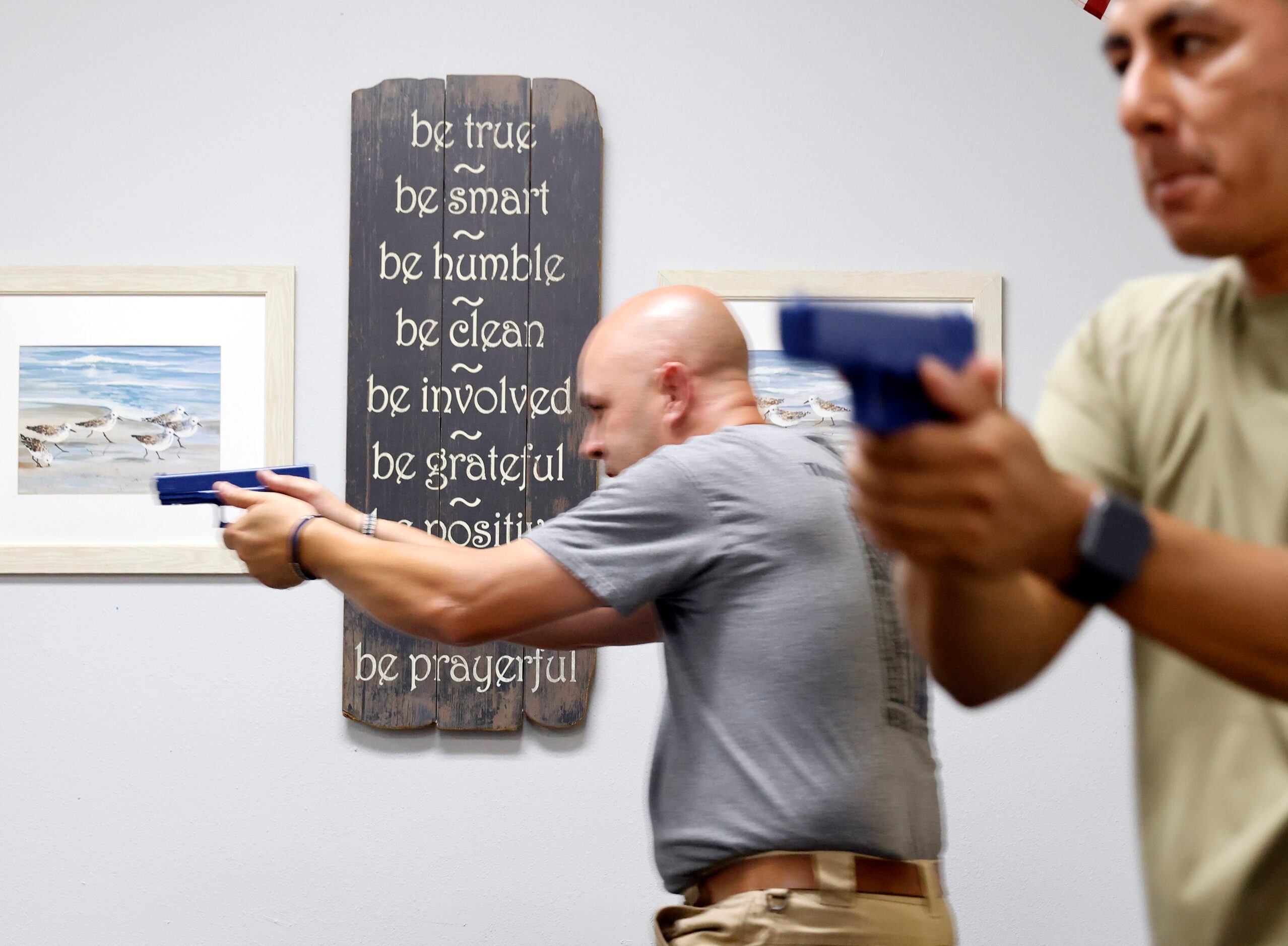 Athens Police Officers James Graham (left) and Rodolfo De La Cruz sweep a teachers work...