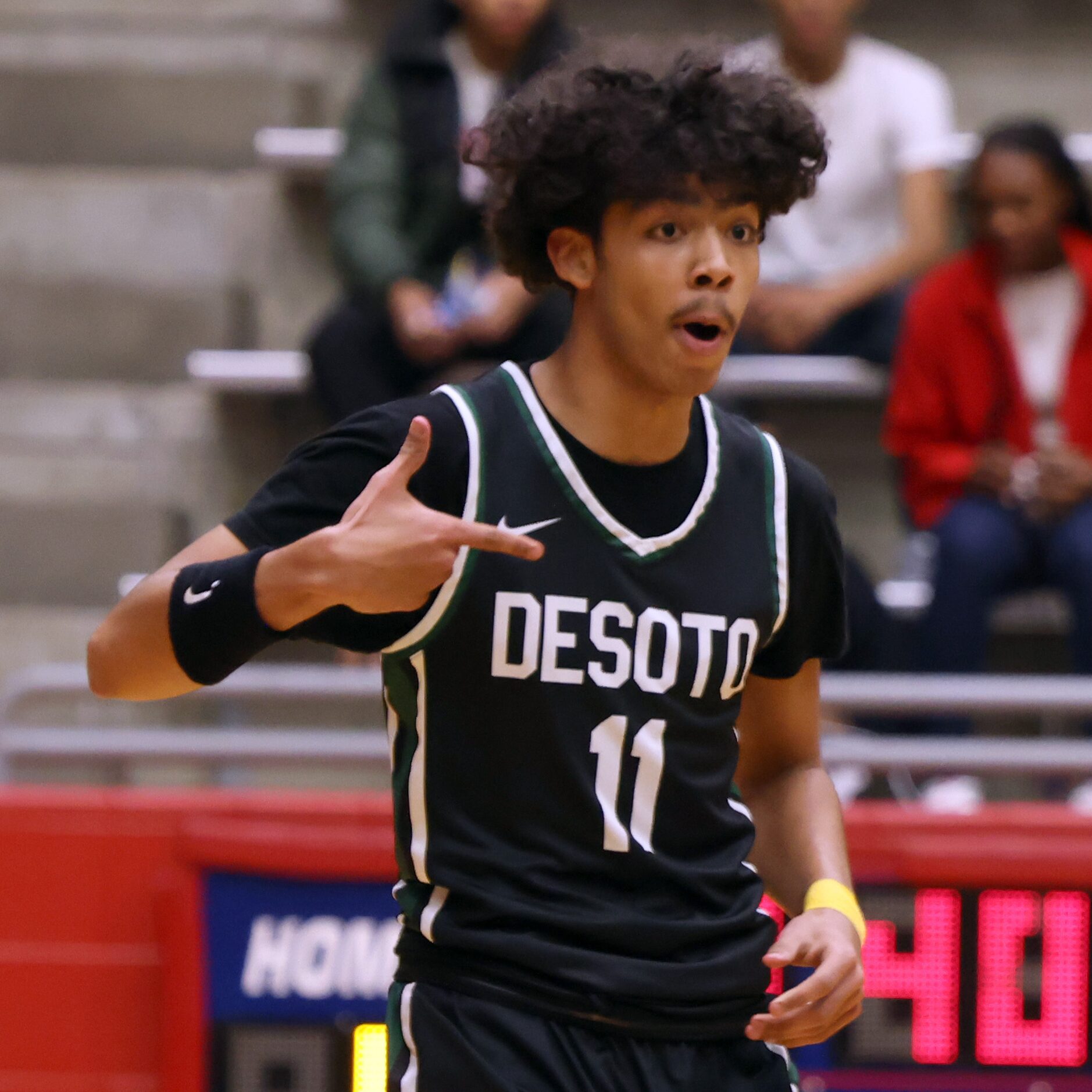 DeSoto guard Acoya King (11) reacts after sinking a 3-pointer during first half action...