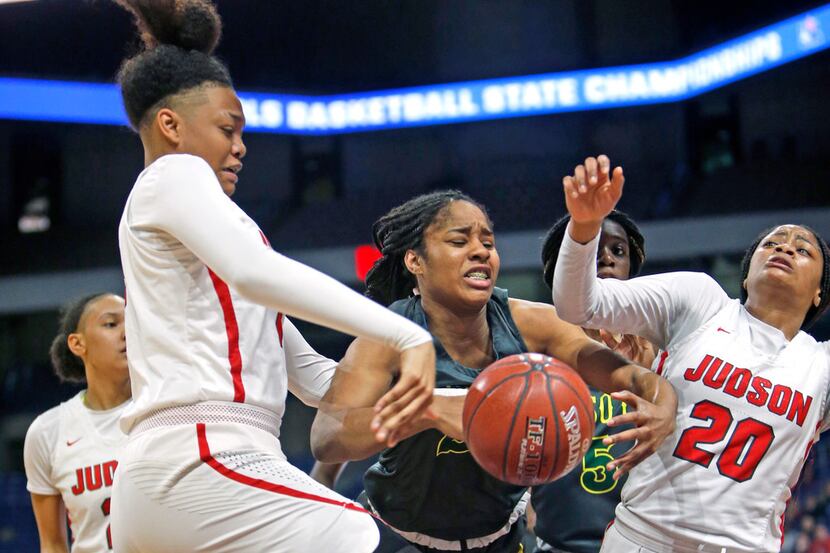 Desoto's Ash'a Thompson fights for the ball between Judson's Elena Blanding and Judson's...