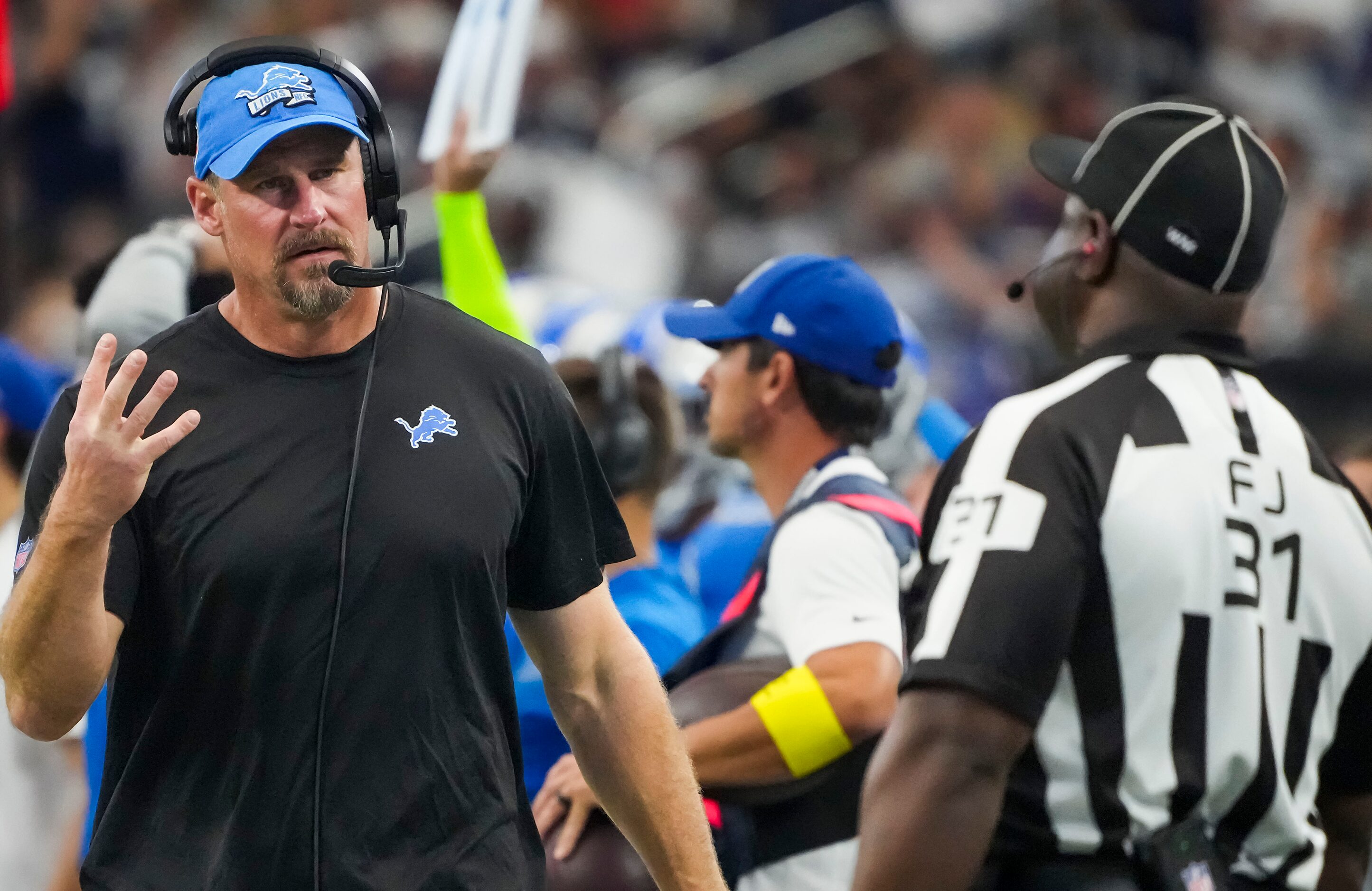 Detroit Lions head coach Dan Campbell looks for a call from field judge Mearl Robinson...