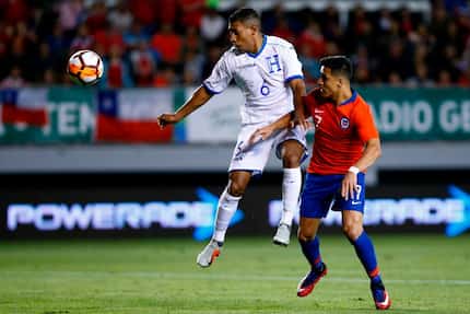Honduras' Bryan Acosta (L) vies for the ball with Chile's Alexis Sanchez during a friendly...