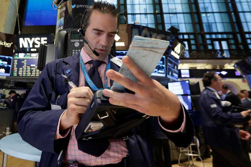 Trader Gregory Rowe works on the floor of the New York Stock Exchange.