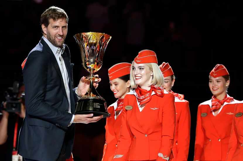 NBA basketball player Dirk Nowitzki holds the James Naismith Trophy, awarded to the FIBA...