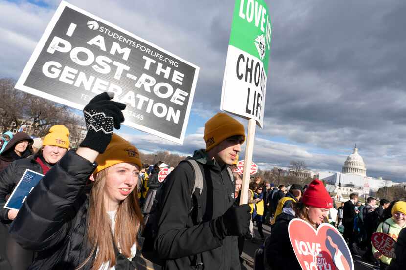 With the U.S. Capitol in the background, anti-abortion demonstrators march toward the U.S....