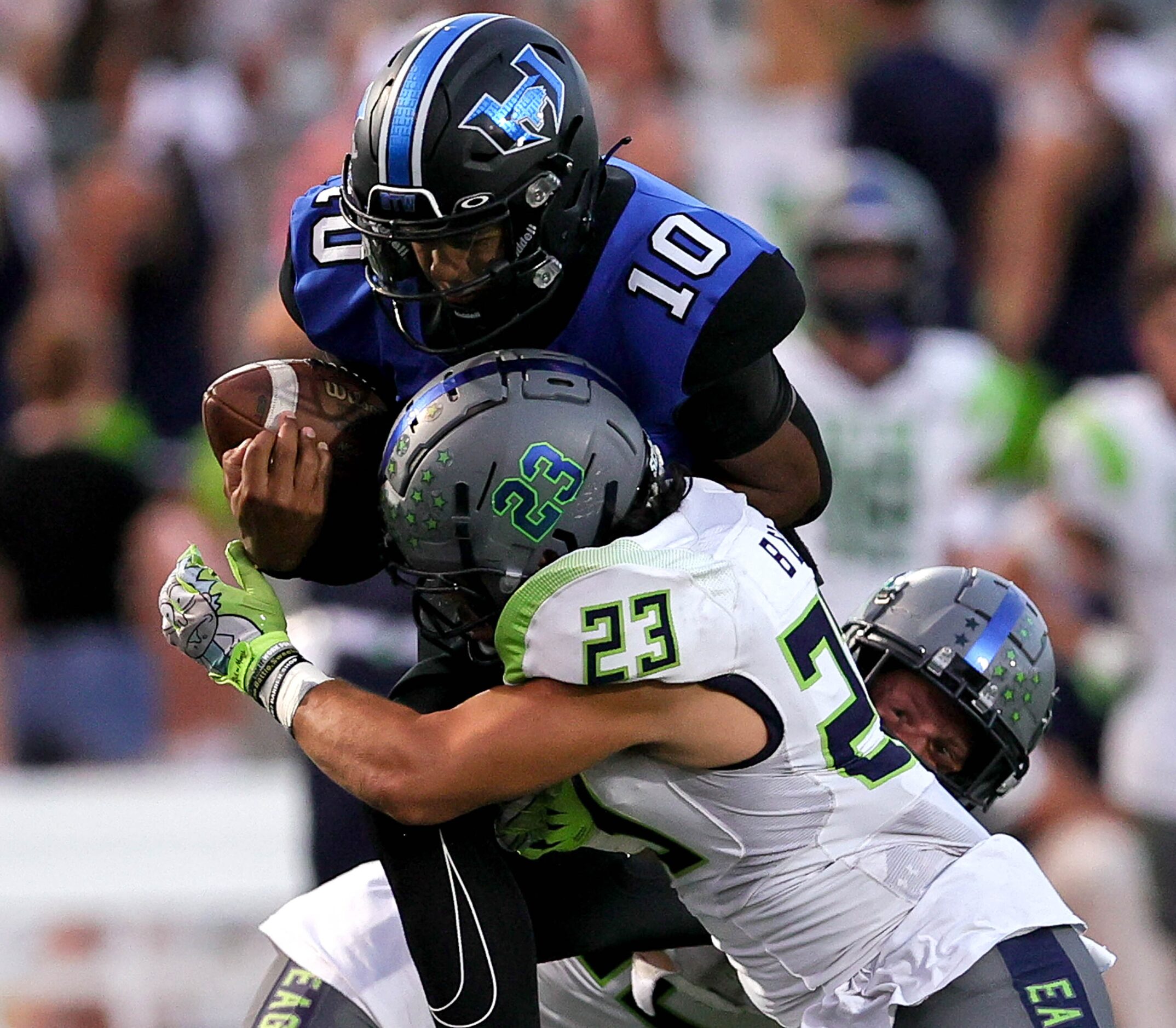 Hebron quarterback Patrick Crayton Jr (10) gets hit hard by Eaton linebacker Kevin Gonzales...