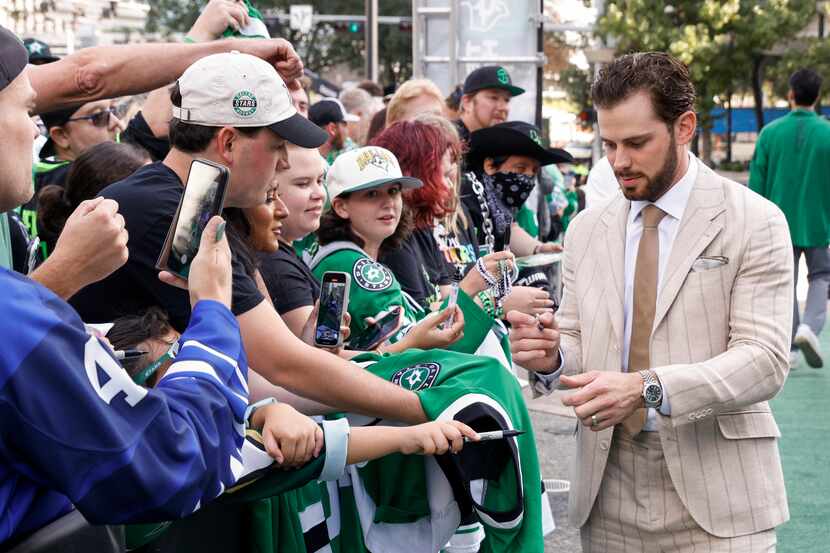 Dallas Stars center Tyler Seguin signs autographs for fans on the green carpet to the...