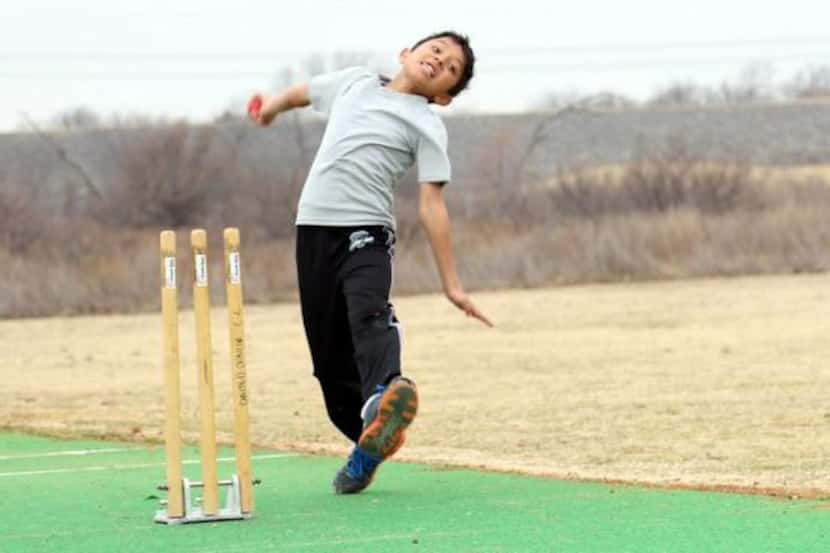 Rishi Ramesh delivers the ball to a batsman on the cricket pitch during a youth mini-camp at...