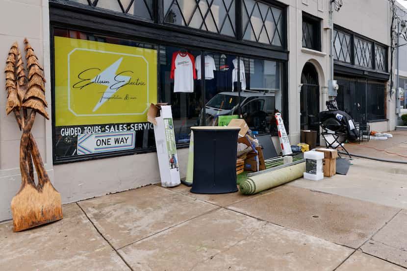 Flood damaged items and carpeting sit along the sidewalk outside of Ellum Electric, an...