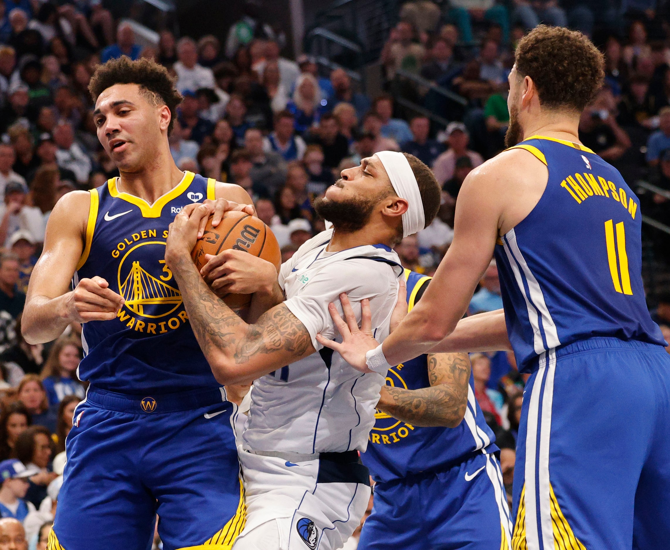 Golden State Warriors forward Trayce Jackson-Davis (32), Dallas Mavericks center Daniel...