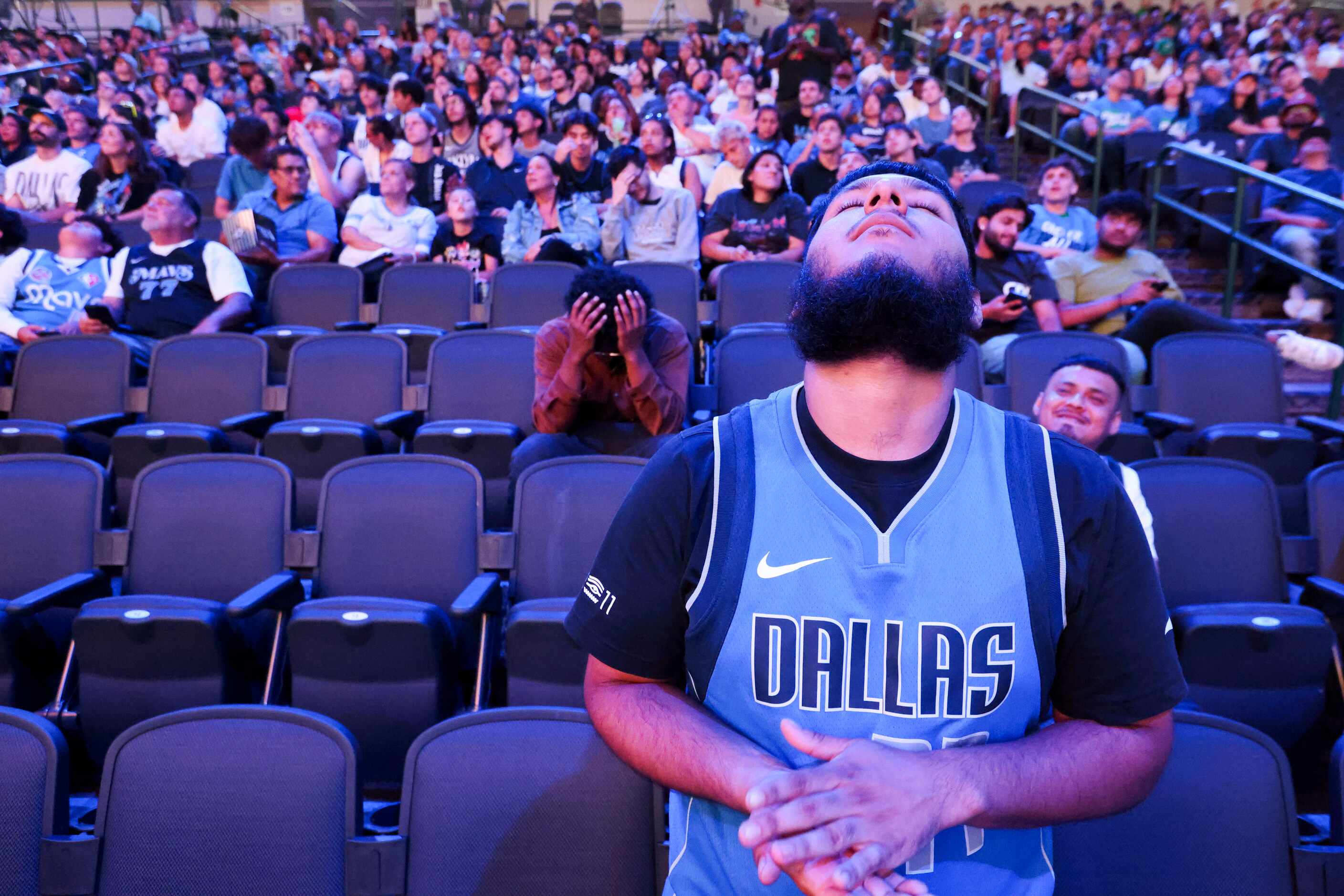 Dallas Mavericks fan Axel Marin with others look dejected followed by the teams’ falling...