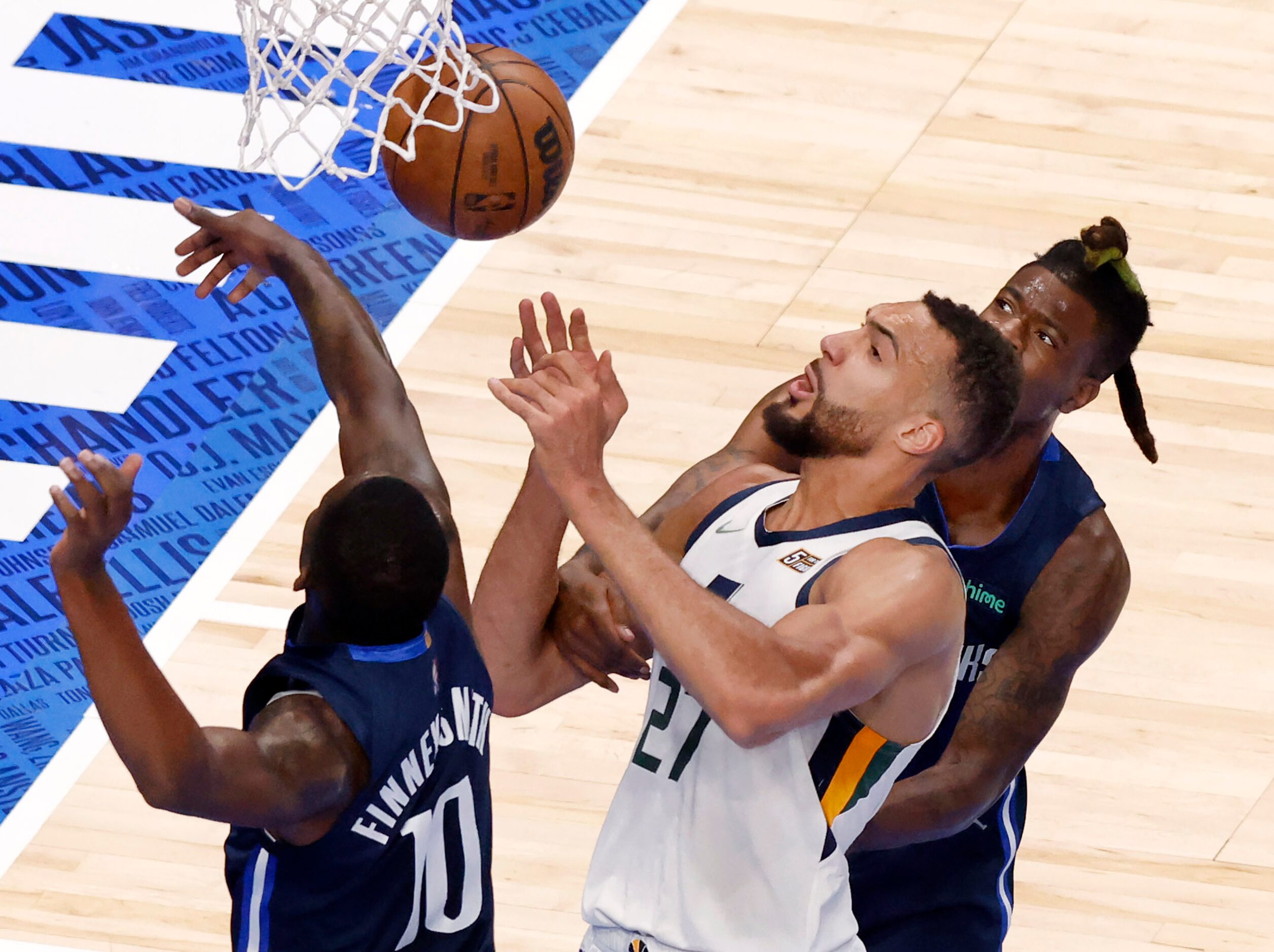 Dallas Mavericks forward Dorian Finney-Smith (10) and forward Reggie Bullock (25) battle...