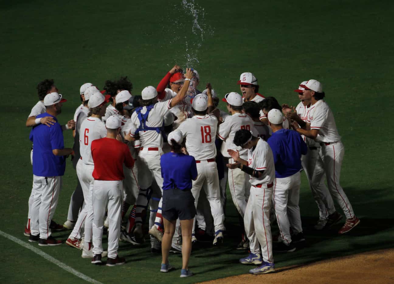 Grapevine players erupt following a praise report from head coach Jimmy Webster after their...