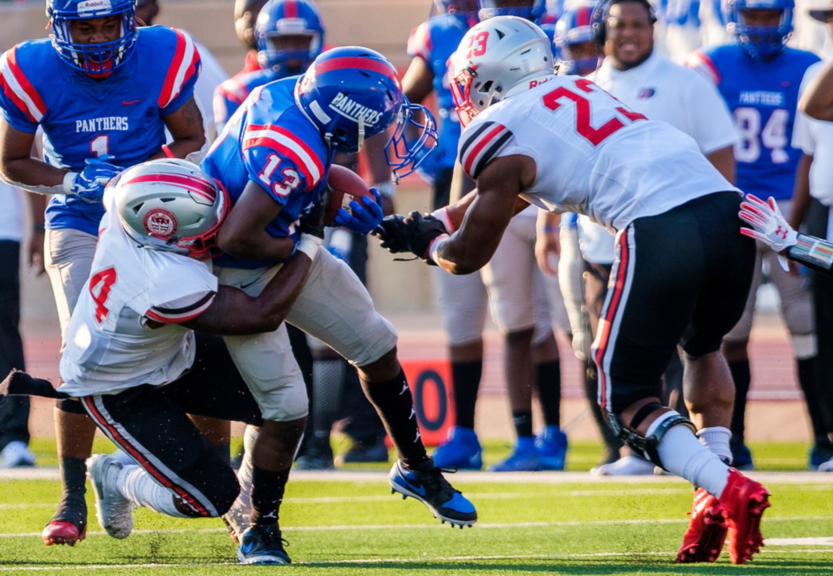 Duncanville wide receiver Roderick Daniels (13) has his facemask come loose as he is brought...