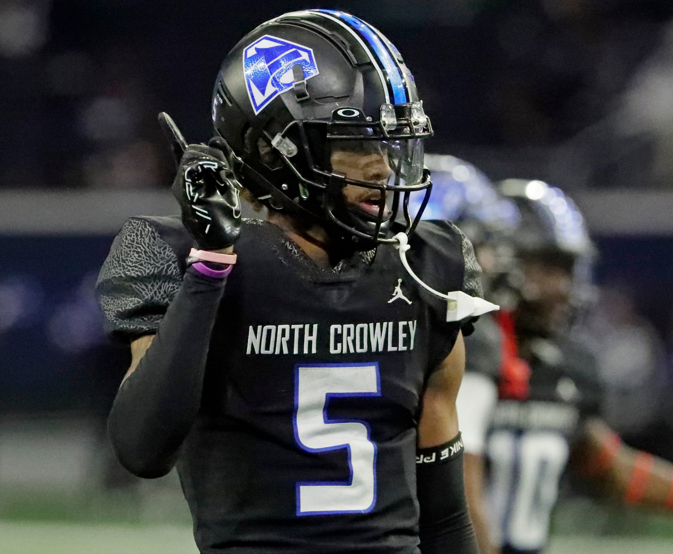 North Crowley High School defensive back Julian Knox (5) sends a message during the first...