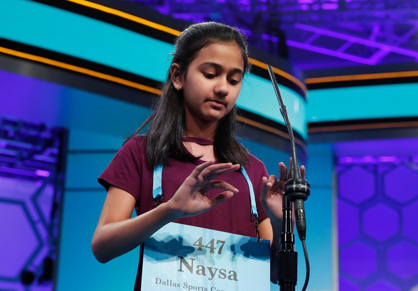 Naysa Modi, 12, from Frisco, Texas, types on an imaginary keyboard as she spells a word...