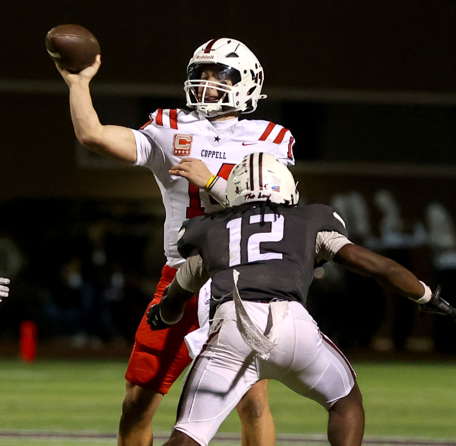 Coppell quarterback Edward Griffin (14) attempts a pass over Lewisville linebacker Michael...