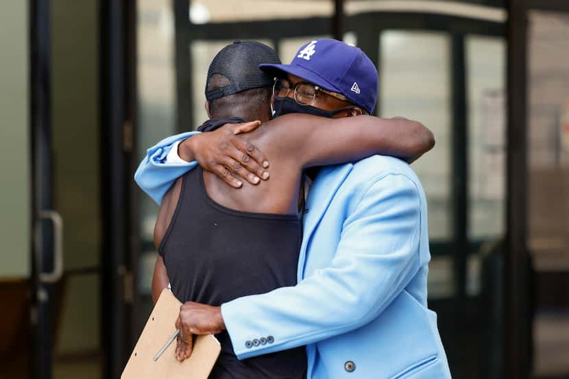 Mark Walters Jr., Luke 4:18 Bail Fund lead organizer (right), embraces Willy Mcnealy after...