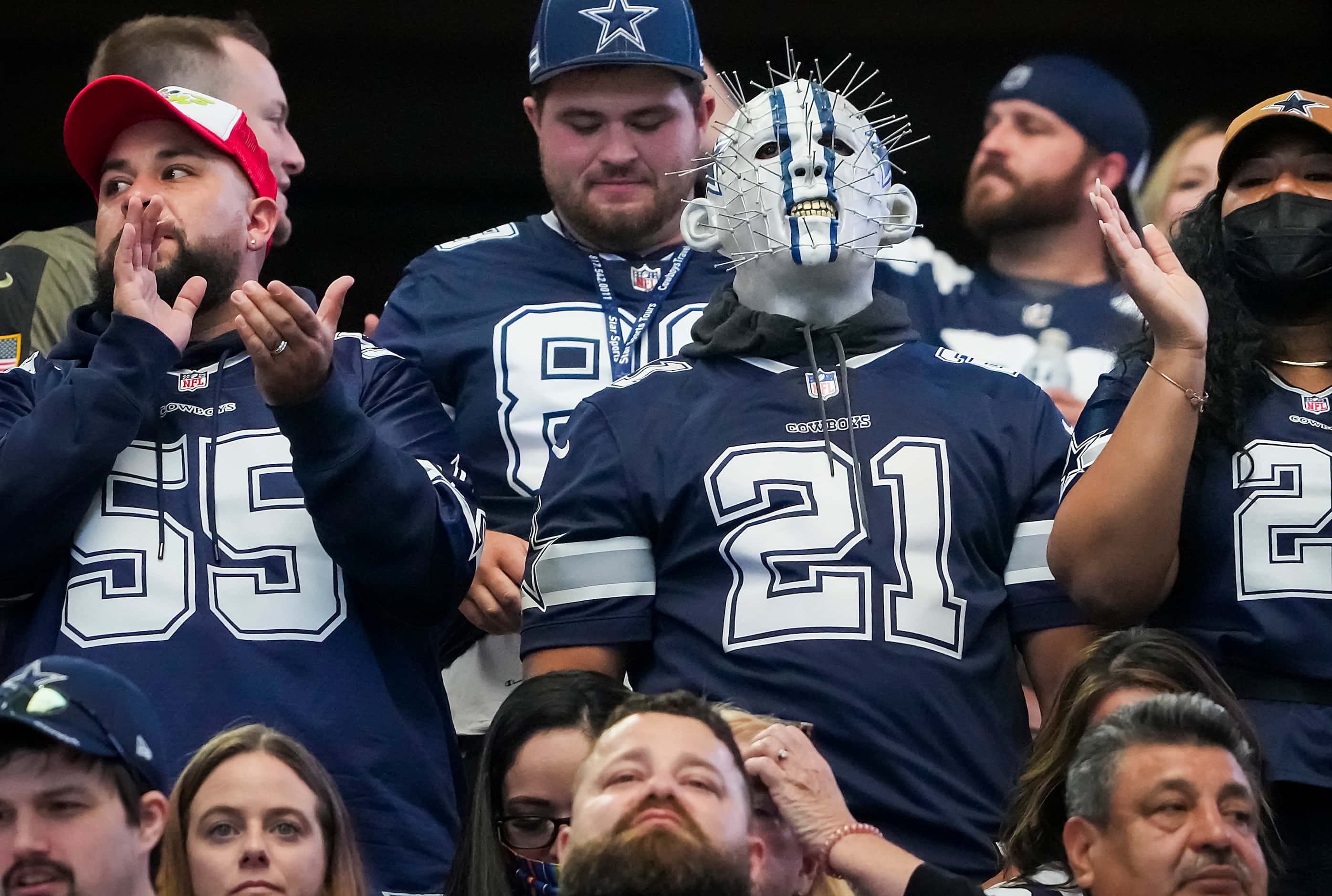 Dallas Cowboys fans watch during the first half of an NFL football game against the Denver...