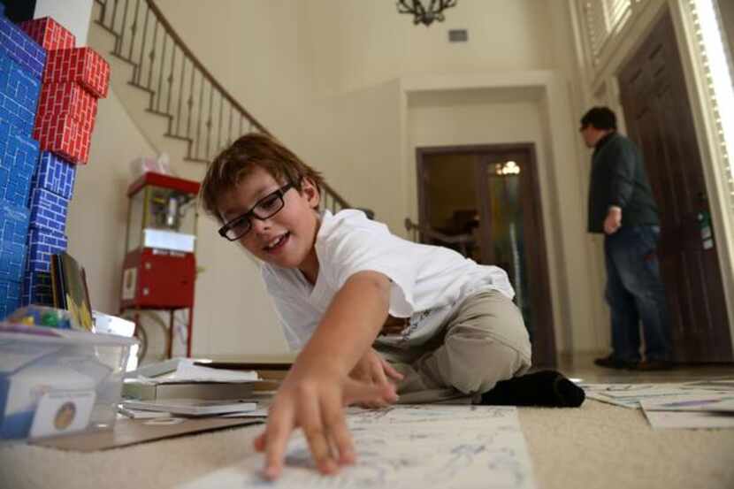 Franklin Wright, 8, explains the rules of one of the board games he created at his Frisco...