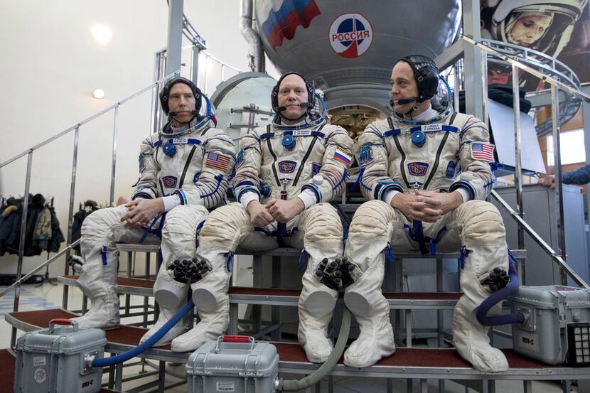 Russian cosmonaut Oleg Artemyev, center, U.S. astronauts Richard Arnold, right, and Andrew...