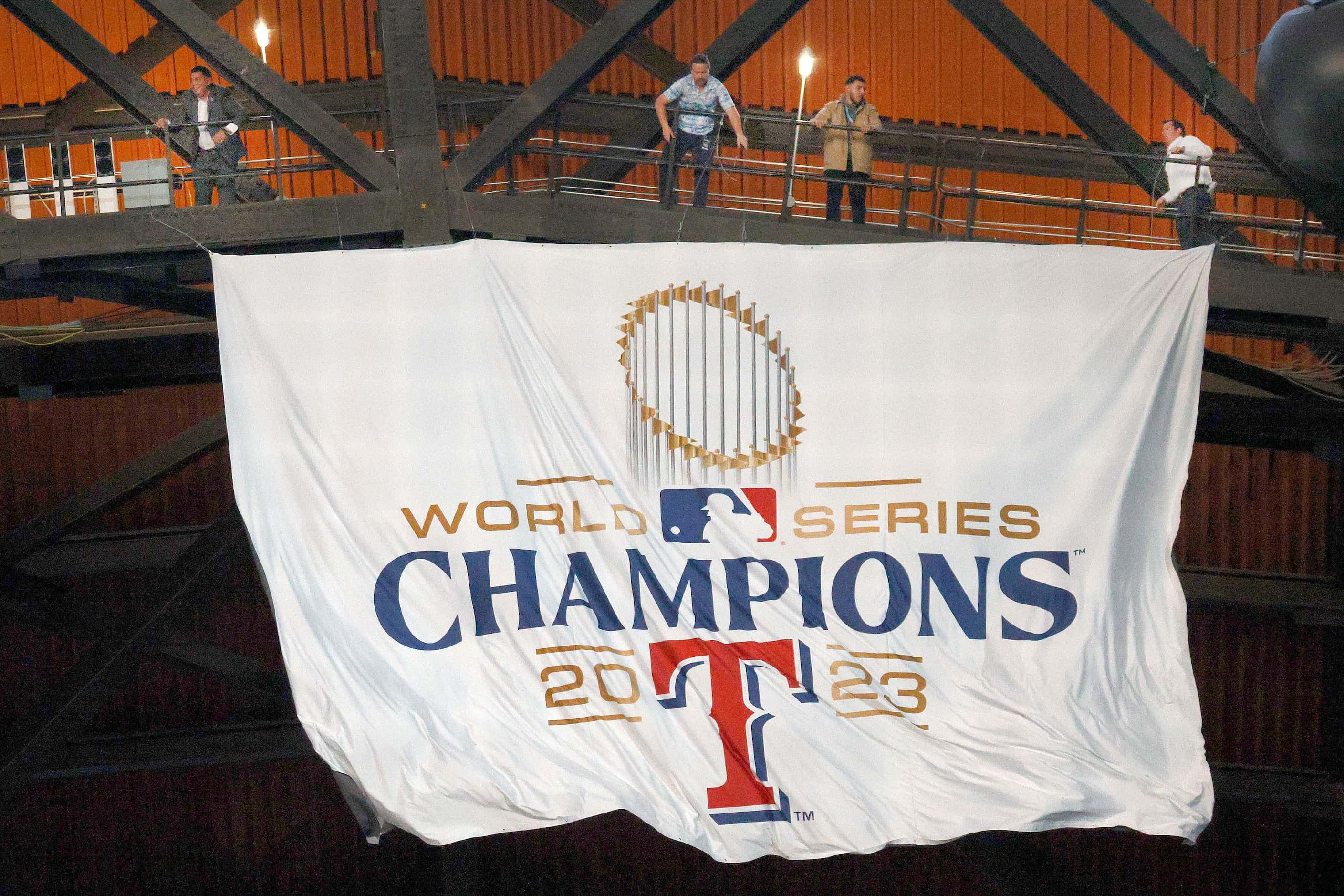 A World Series Championship banner is unveiled before the Texas Rangers home opener against...