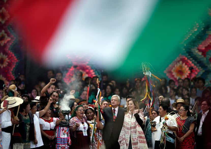 Lopez Obrador holds a chieftain's staff during a traditional indigenous ceremony at the...