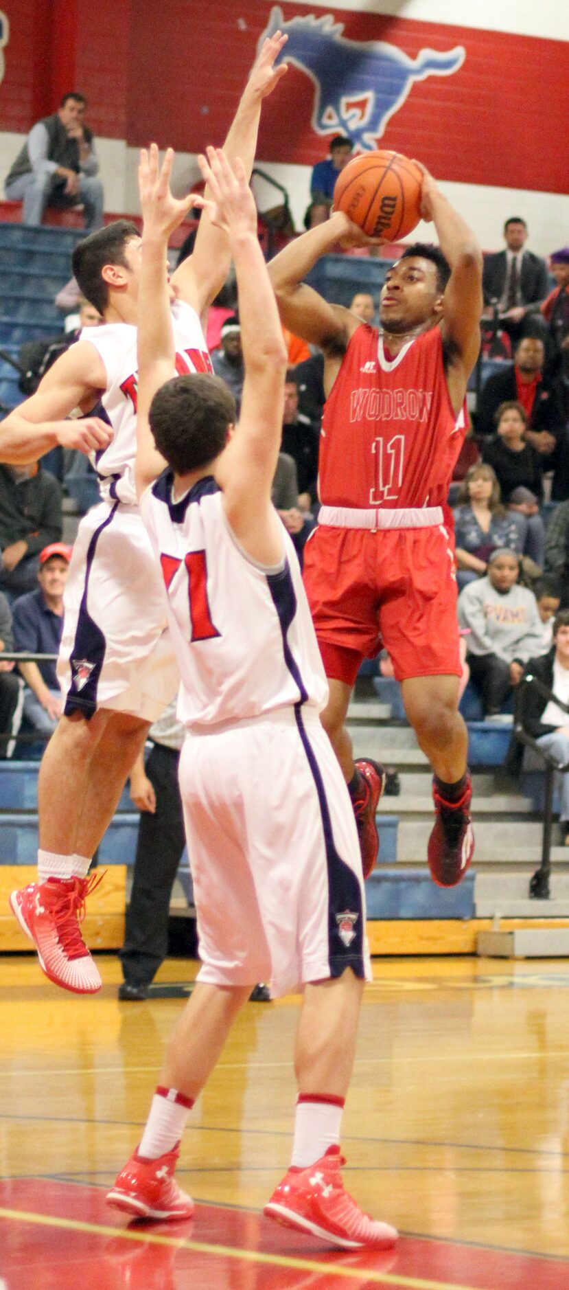 Woodrow Wilson guard Craig Martin (11) goes up for a last second shot attempt as he is...