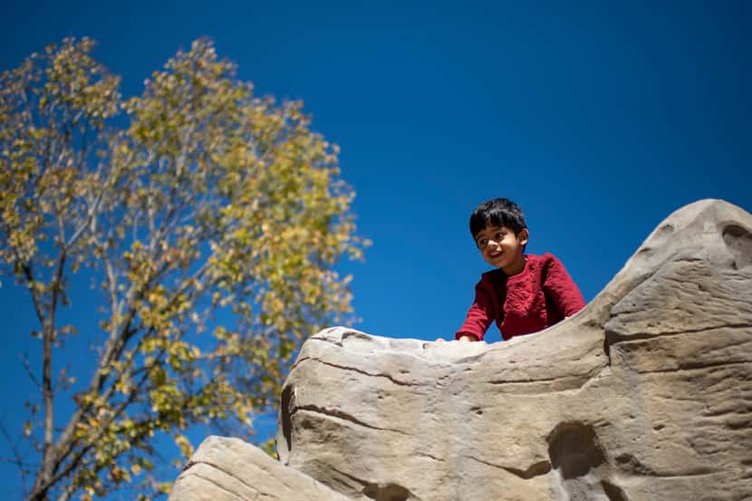 Four-year-old Neil Sathe peered down the new South Oak Cliff Renaissance Park, in a file...