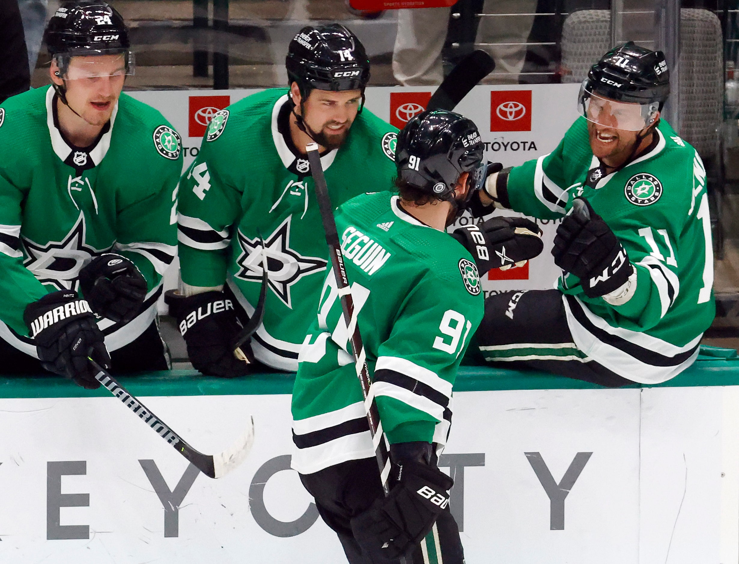 Dallas Stars center Roope Hintz (24), left wing Jamie Benn (14) and center Luke Glendening...