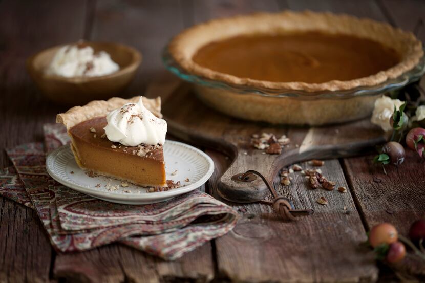 Holiday Thanksgiving slice of pumpkin pie with whipped topping