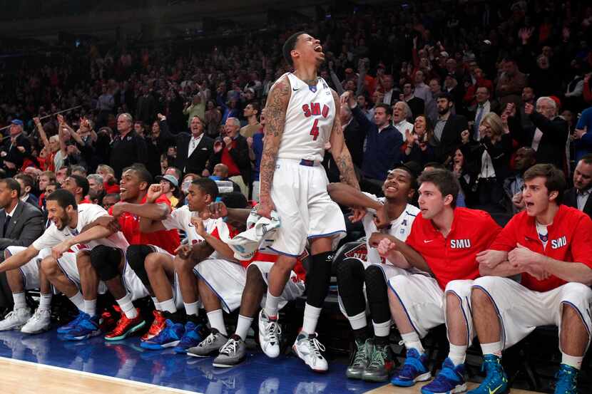 SMU guard Keith Frazier (4) and teammates celebrate as SMU makes free throws during the...