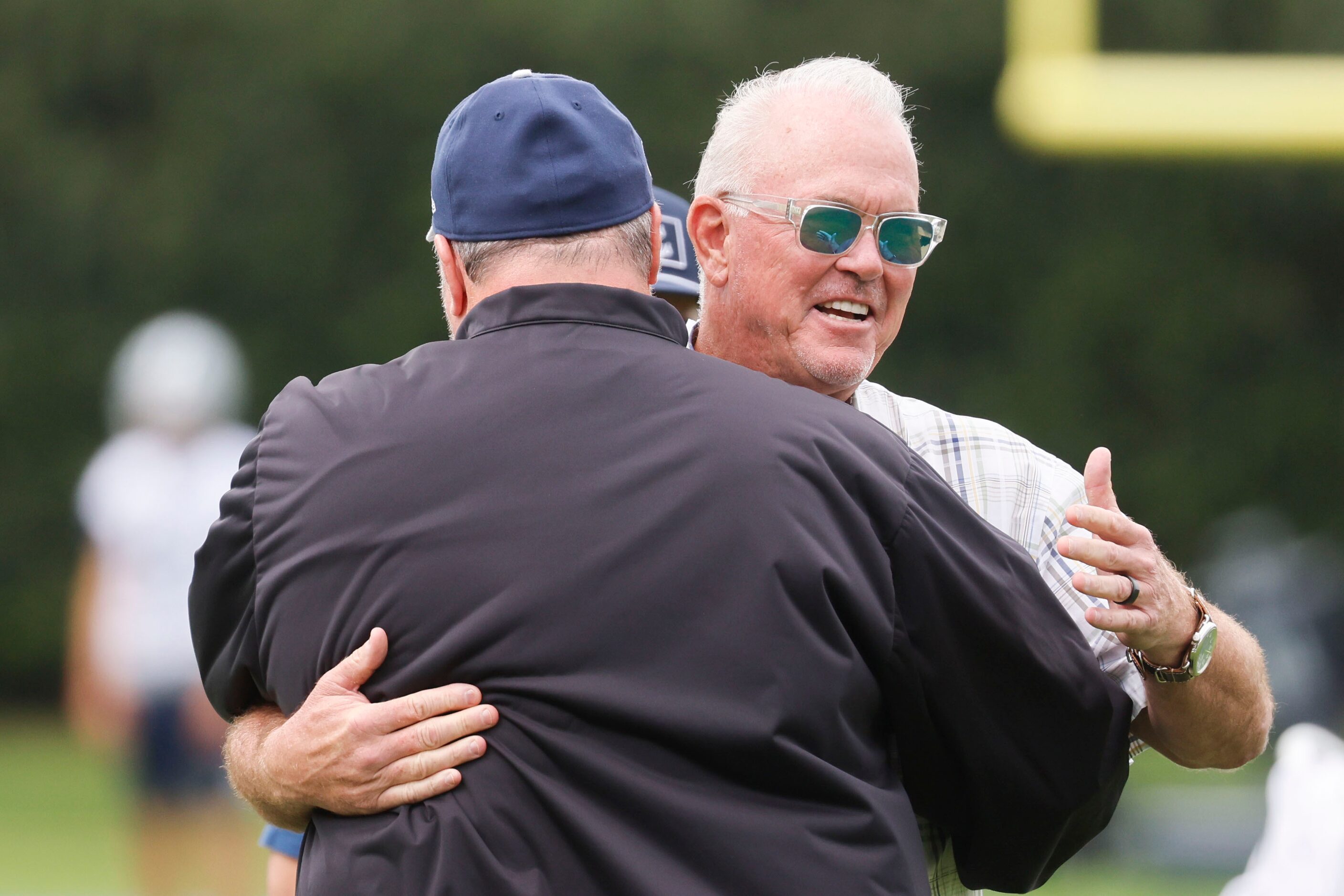 Dallas Cowboys head coach Mike McCarthy (front) hugs Dallas Cowboys Executive vice president...