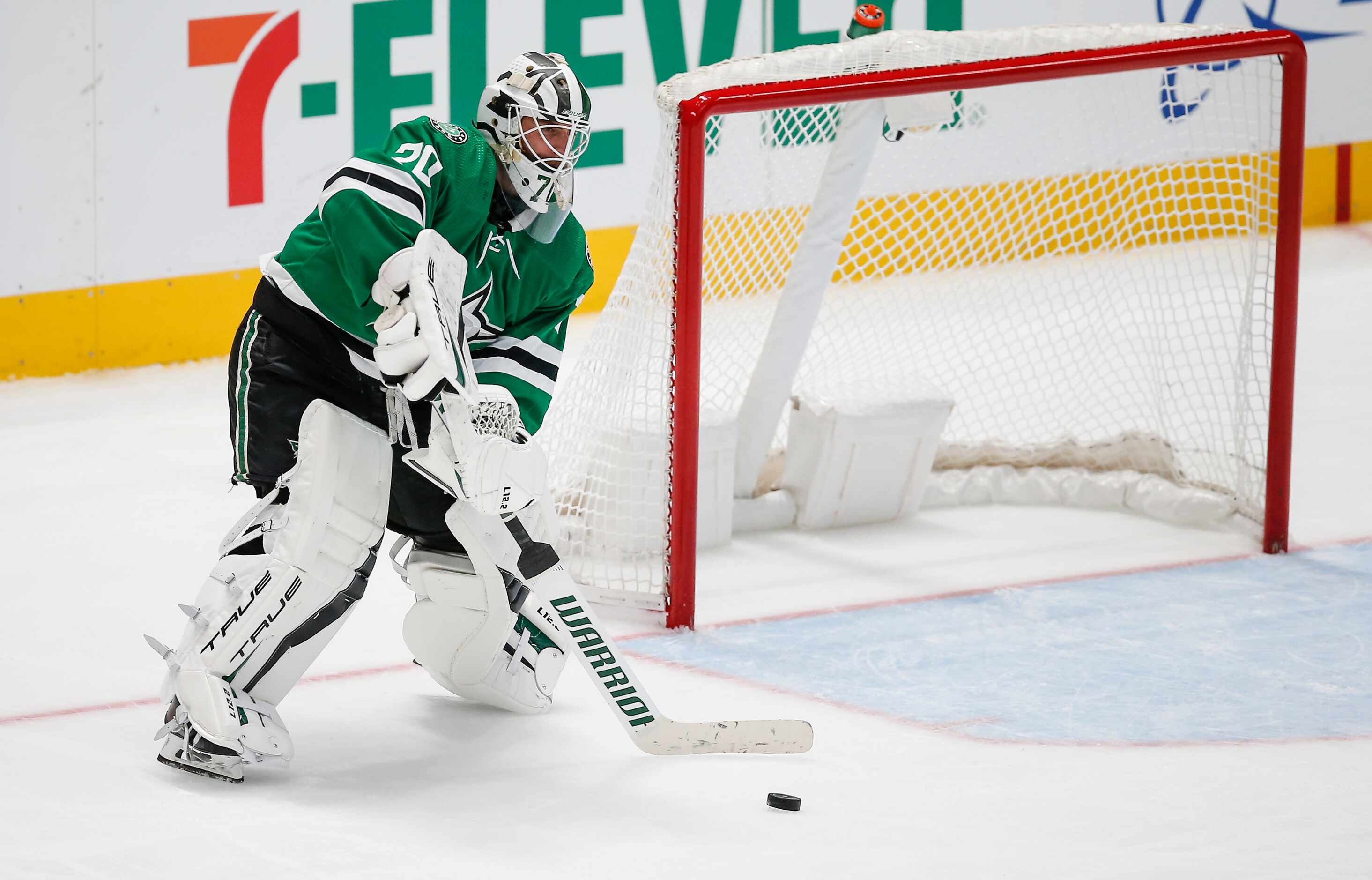 Dallas Stars goaltender Braden Holtby (70) plays the puck away from the net during the...